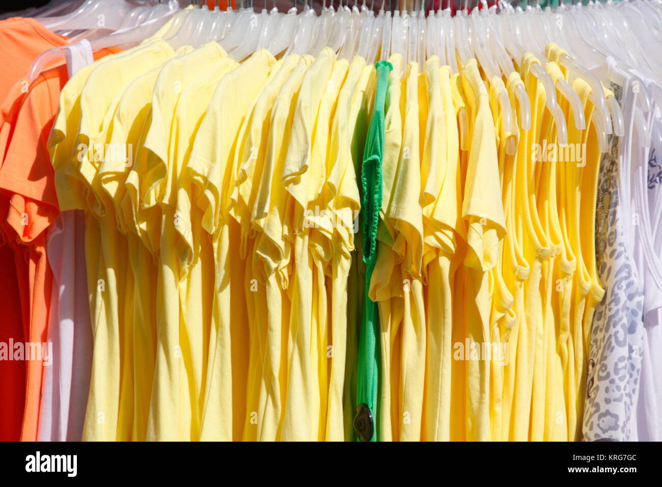 colorful t-shirts on a clothes rail Stock Photo