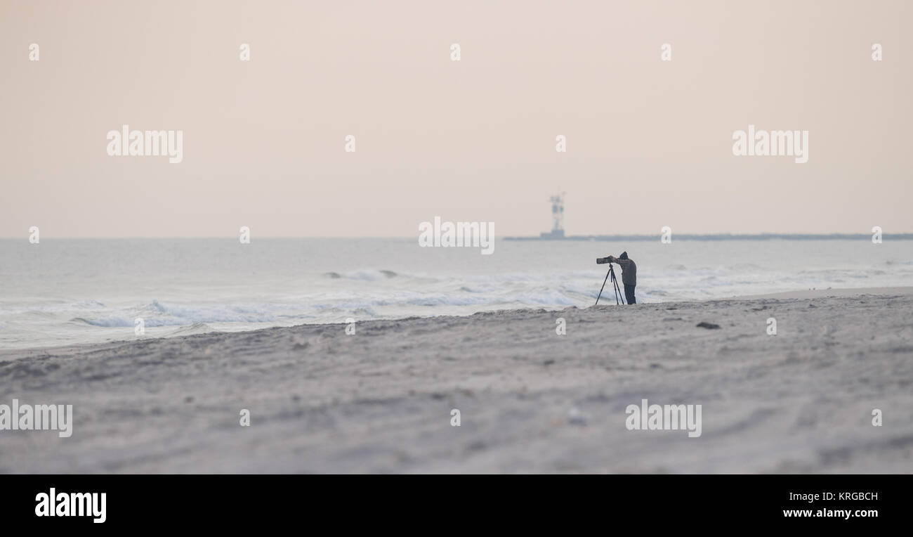 A photographer on the beach Stock Photo