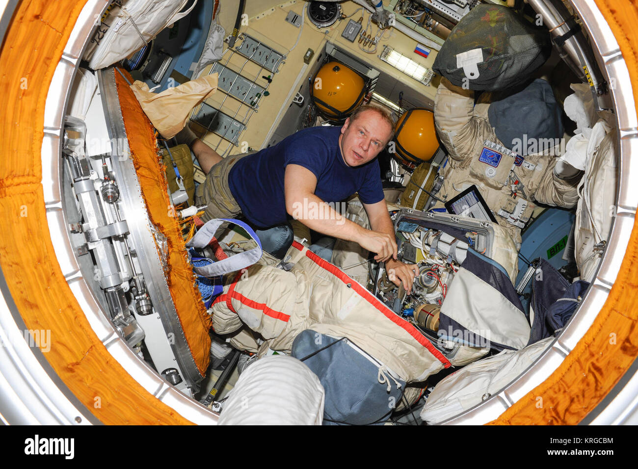 ISS-37 Oleg Kotov works with a Russian Orlan spacesuit in the Pirs module Stock Photo