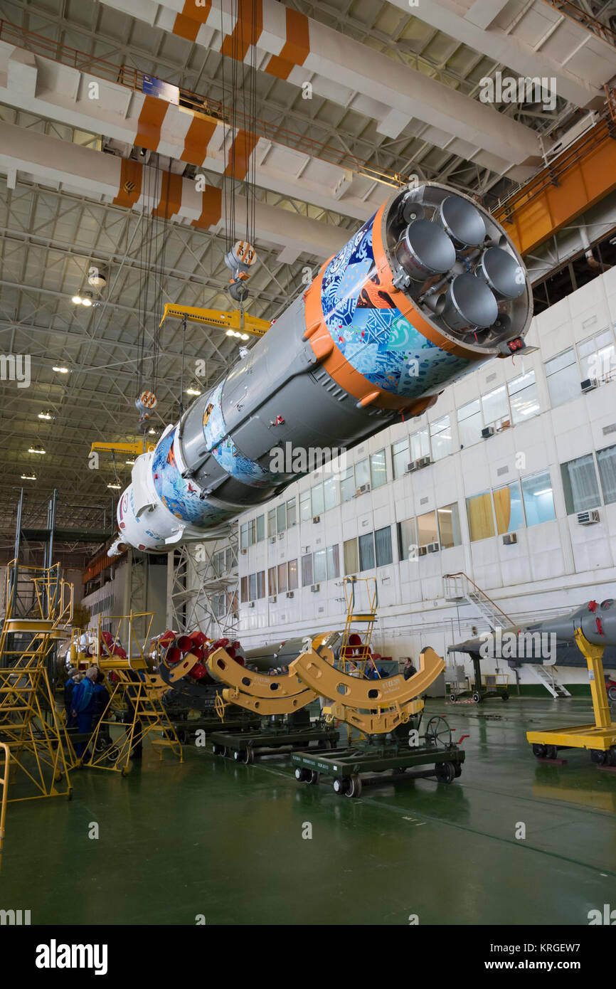 Workers make final preperations to a Soyuz TMA-11M spacecraft on Monday, Nov. 4, 2013, at the Baikonur Cosmodome in Baikonur, Kazakhstan. The rocket is adorned with the logo of the Sochi Olympic Organizing Committee and other related artwork to commemorate the launch of the Olympic torch with the crew for a four-day visit to the station. The torch will return to Earth with another trio of station residents on Nov. 11 and will be part of the torch relay that ends with the lighting of the flame at the Fisht Stadium in Sochi, Russia Feb. 7 to mark the opening of the 2014 Winter Olympics. Photo Cr Stock Photo