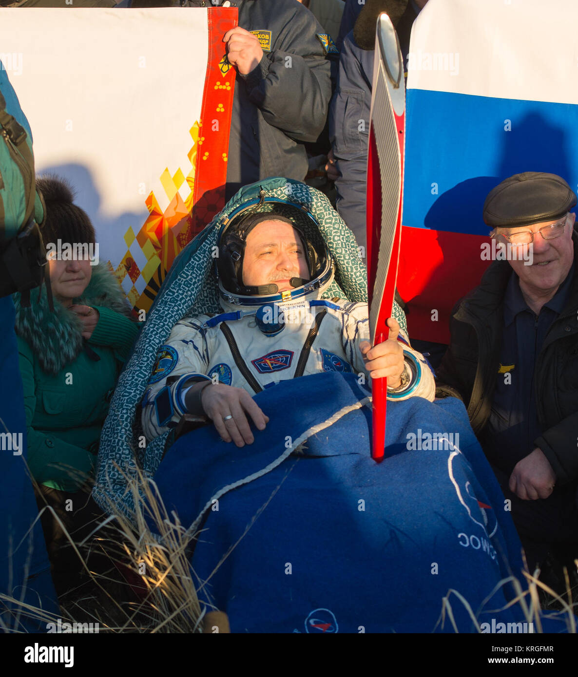 Expedition 37 Commander Fyodor Yurchikhin is seen holding the Olympic torch minutes after he and his crew landed in a remote area southeast of the town of Zhezkazgan, Kazakhstan, on Monday, Nov. 11, 2013.  The Olympic torch was launched with the crew of Expedition 38 to the International Space Station on November 7.  It was passed from one module to the next and had its first spacewalk on November 9 with two Russian cosmonauts as part of its international relay.  Now back on earth it will continue its journey to Sochi, Russia for the 2014 Winter Games.  Photo Credit: (NASA/Carla Cioffi) Soyuz  Stock Photo