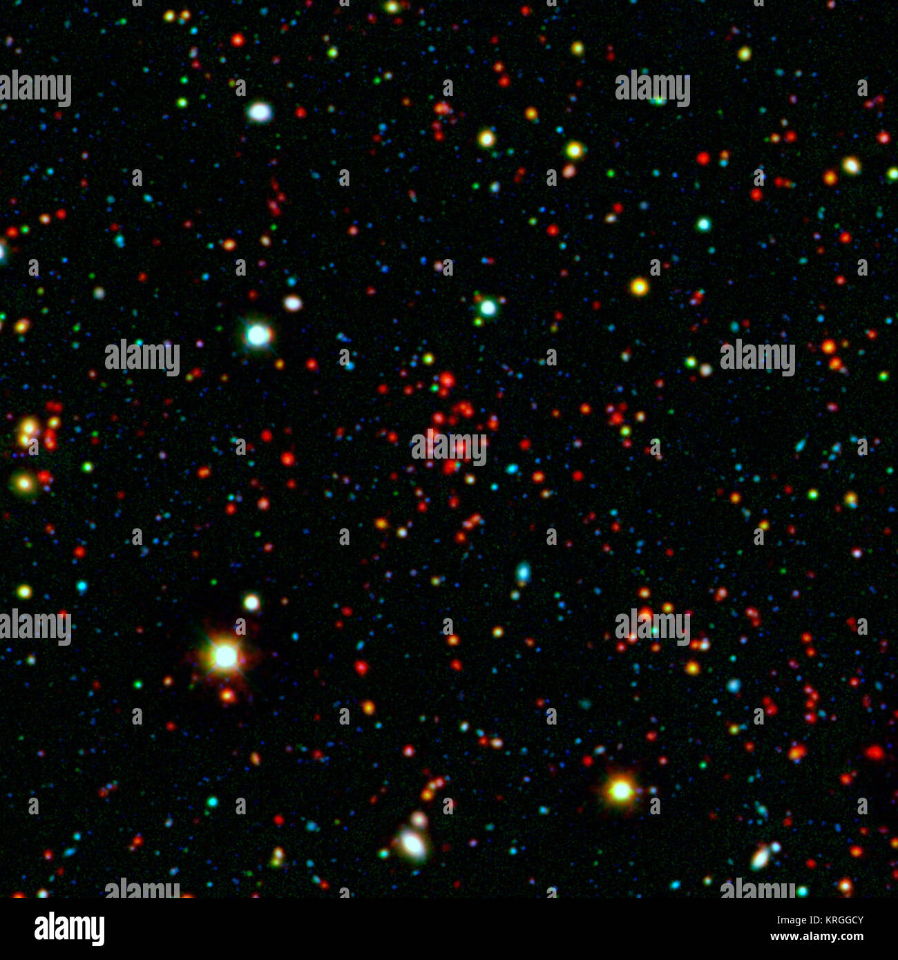 The collection of red dots seen near the center of this image show one of several very distant galaxy clusters discovered by combining ground-based optical data from the National Optical Astronomy Observatory's Kitt Peak National Observatory with infrared data from NASA's Spitzer Space Telescope. This galaxy cluster, named ISCS J1434.7+3519, is located about 9 billion light-years from Earth.   The large white and yellow dots in this picture are stars in our galaxy, while the rest of the smaller dots are distant galaxies. The cluster, comprised of red dots near the center, includes more than 10 Stock Photo