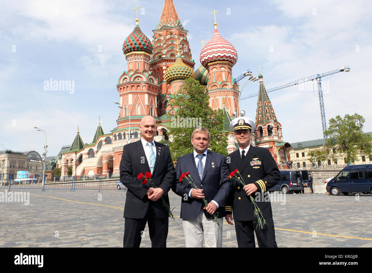 1034:  In front of St. Basil’s Cathedral in Moscow’s Red Square, Expedition 40/41 Flight Engineer Alexander Gerst of the European Space Agency (left), Soyuz Commander Max Suraev of the Russian Federal Space Agency (Roscosmos, center) and Flight Engineer Reid Wiseman of NASA (right) pose for pictures May 8 before laying flowers at the Kremlin Wall where Russian space icons are interred. The trio is preparing for launch May 29, Kazakh time, in the Soyuz TMA-13M spacecraft from the Baikonur Cosmodrome in Kazakhstan for a 5 ½ month mission on the International Space Station.  NASA/Stephanie Stoll  Stock Photo