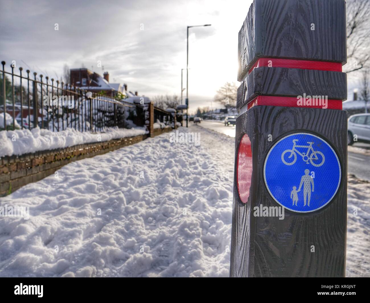 Walk and cycle sign with pathway filled with snow Stock Photo