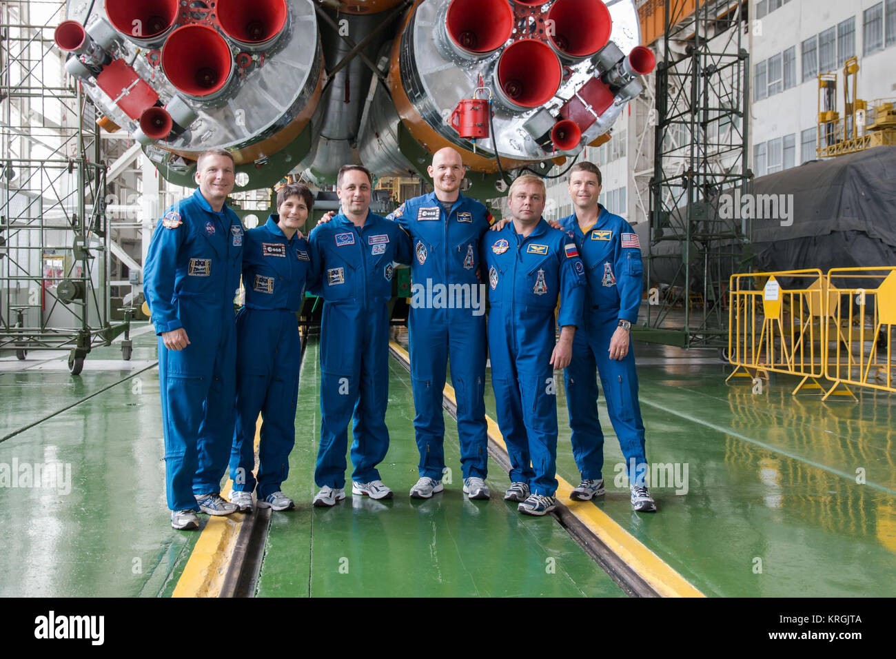 13-16-01-3:  At the Baikonur Cosmodrome in Kazakhstan, the Expedition 40/41 backup and prime crewmembers pose for pictures in front of the Soyuz booster rocket’s first stage engines May 24 during the final fit check training dress rehearsal. From left to right are backup crewmembers Terry Virts of NASA, Samantha Cristoforetti of the European Space Agency, Anton Shkaplerov of the Russian Federal Space Agency (Roscosmos), and prime crewmembers Flight Engineer Alexander Gerst of the European Space Agency, Soyuz Commander Max Suraev of Roscosmos and Flight Engineer Reid Wiseman of NASA. Gerst, Sur Stock Photo