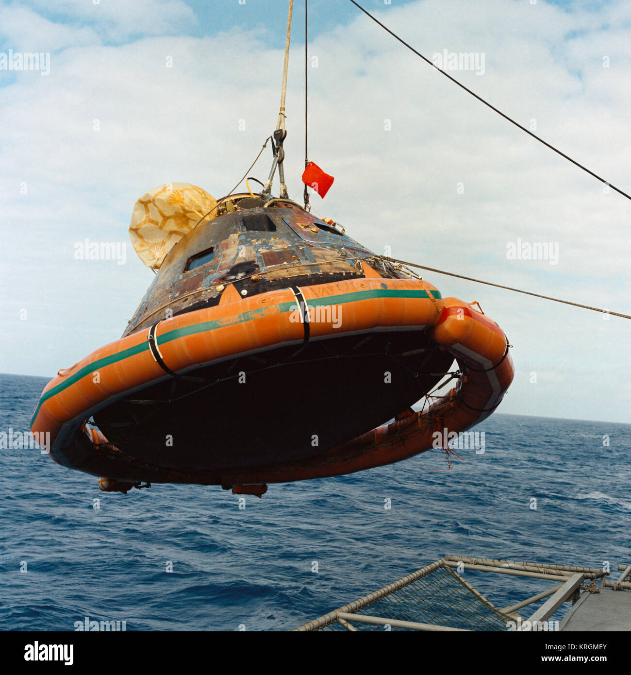 S69-21783 (24 July 1969) --- The Apollo 11 Command Module (CM) is photographed as it is hoisted aboard the USS Hornet, prime recovery vessel for the historic Apollo 11 lunar landing mission. The splashdown took place at 11:49 a.m. (CDT), July 24, 1969, about 812 nautical miles southwest of Hawaii, only 12 nautical miles from the USS Hornet. Apollo 11 CM hoisted aboard Hornet (S69-21783) Stock Photo