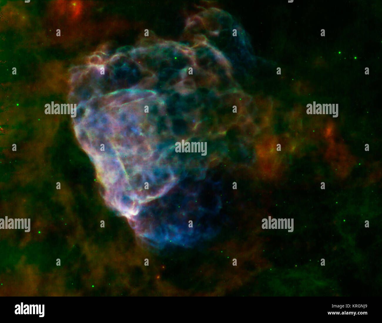 The destructive results of a mighty supernova explosion reveal themselves in a delicate blend of infrared and X-ray light, as seen in this image from NASA’s Spitzer Space Telescope and Chandra X-Ray Observatory, and the European Space Agency's XMM-Newton.   The bubbly cloud is an irregular shock wave, generated by a supernova that would have been witnessed on Earth 3,700 years ago. The remnant itself, called Puppis A, is around 7,000 light-years away, and the shock wave is about 10 light-years across.  The pastel hues in this image reveal that the infrared and X-ray structures trace each other Stock Photo