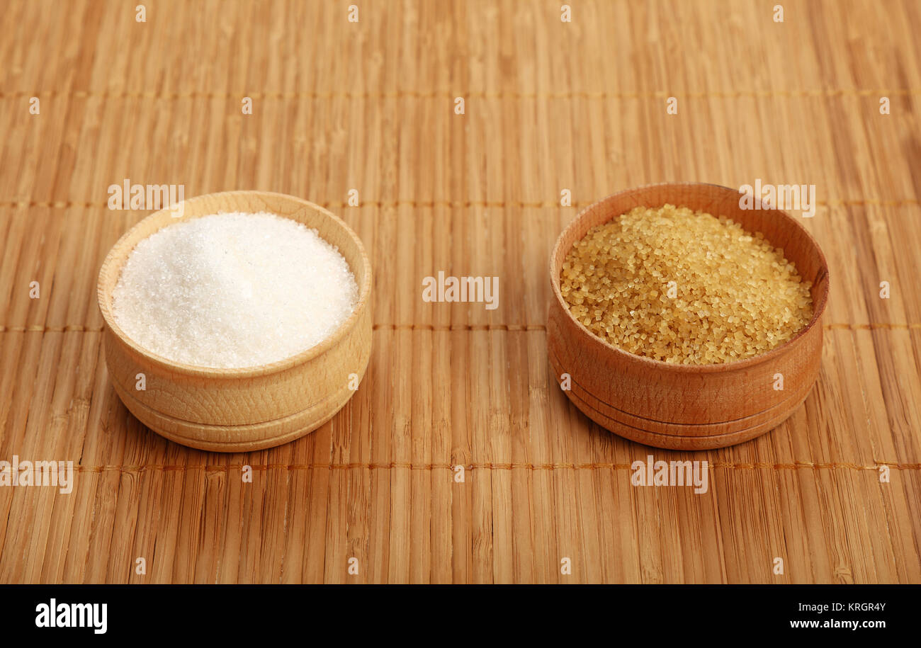 White and brown cane sugar in wooden bowls on mat Stock Photo Alamy