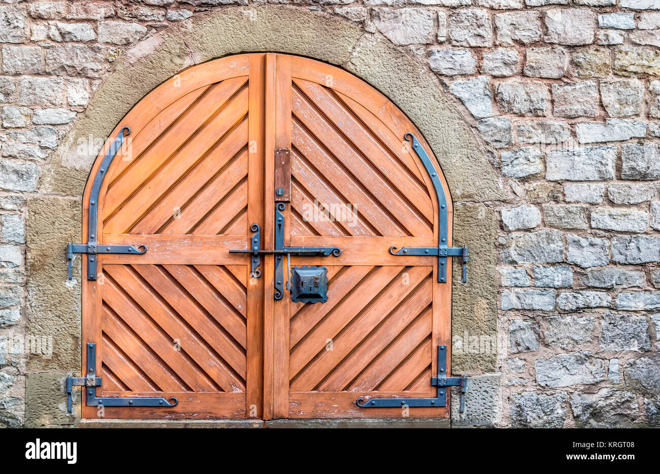 Double wooden door and stone wall Stock Photo