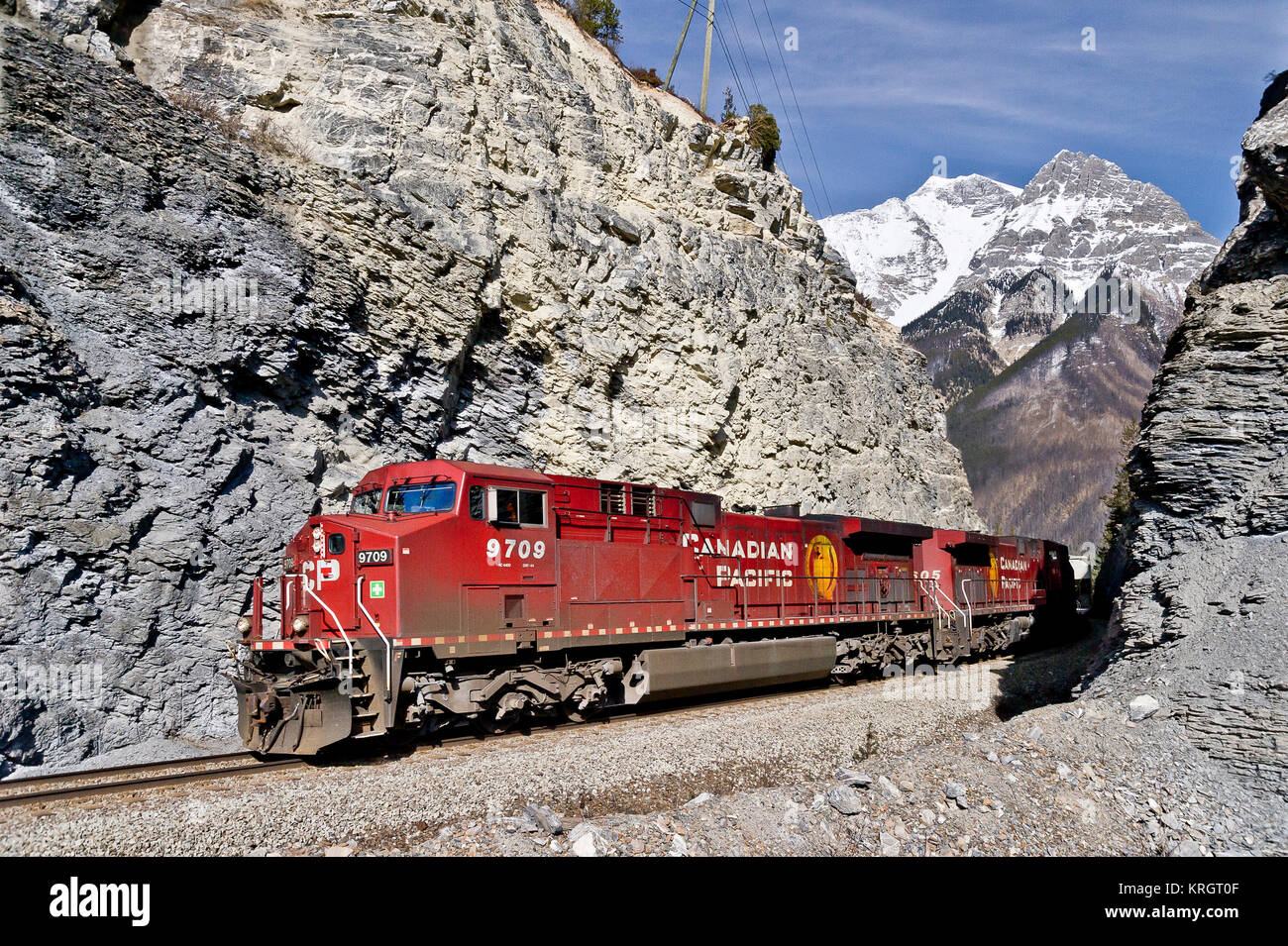 CP Rail mixed freight led by loco 9709 westbound through Leanchoil in Yoho National Park - BC Stock Photo