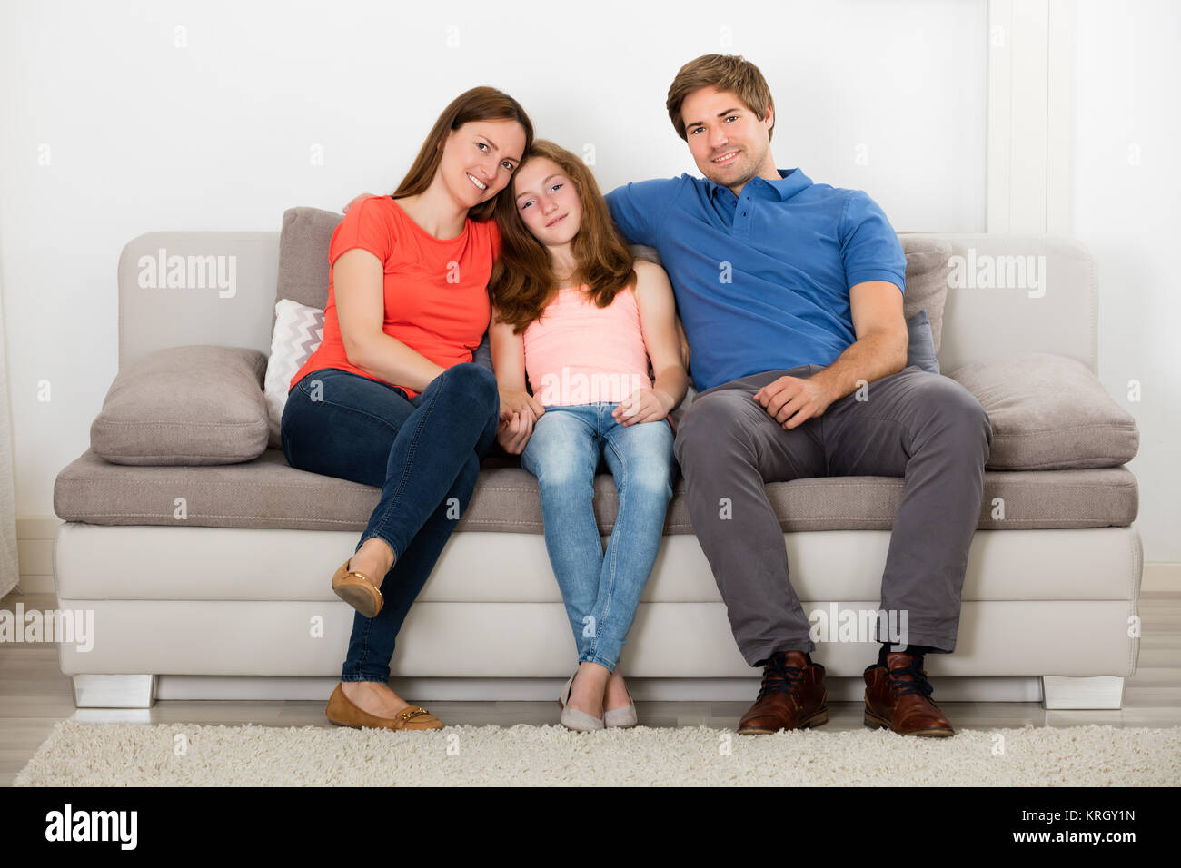 Family Sitting On Sofa Stock Photo