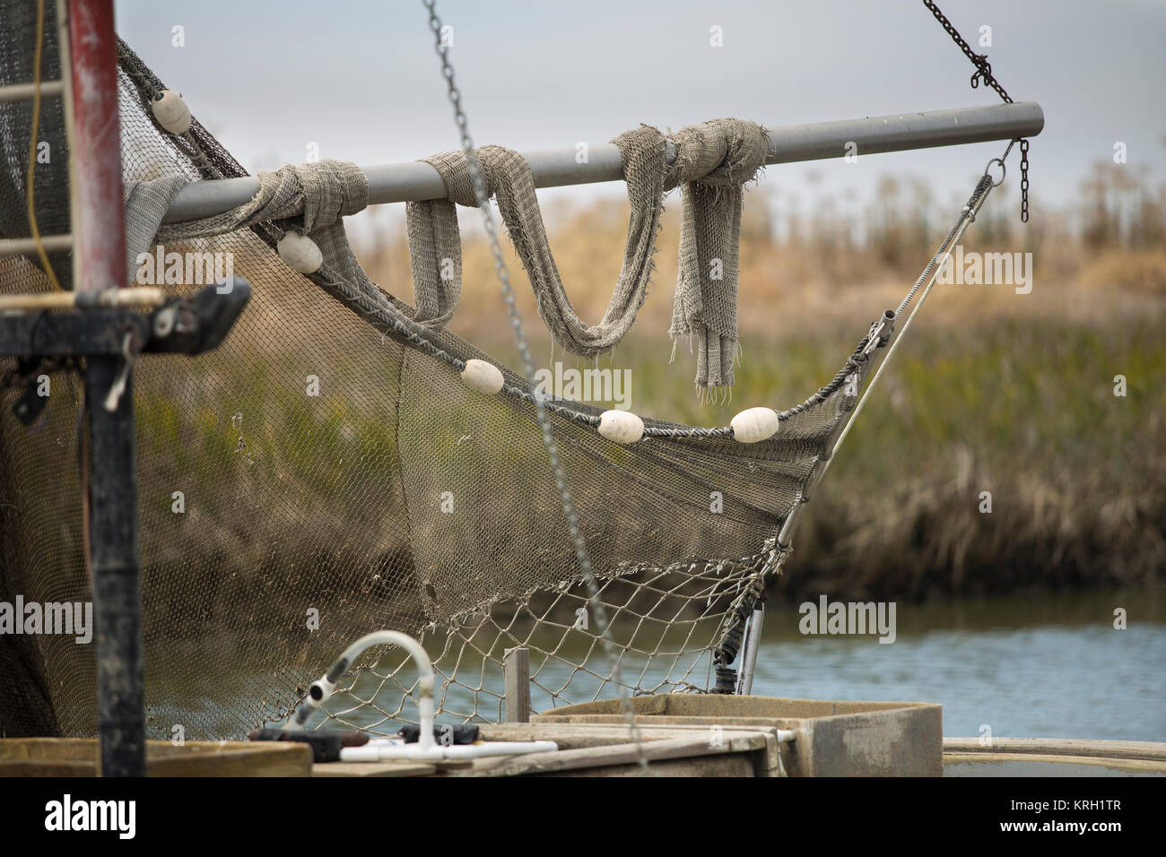 Fishing net hanging on an old commercial fishing boat Stock Photo