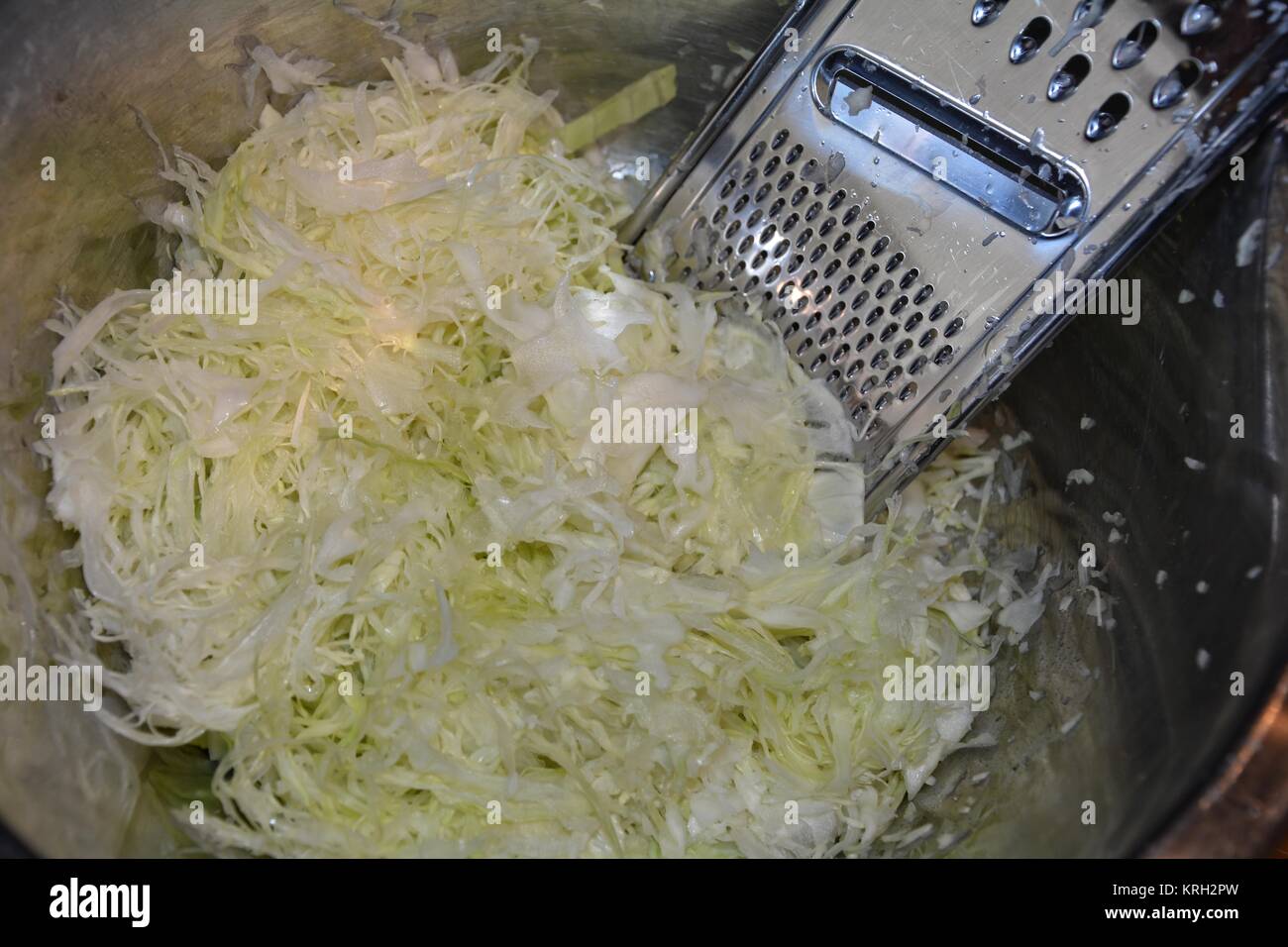 freshly grated cabbage with slicer Stock Photo Alamy