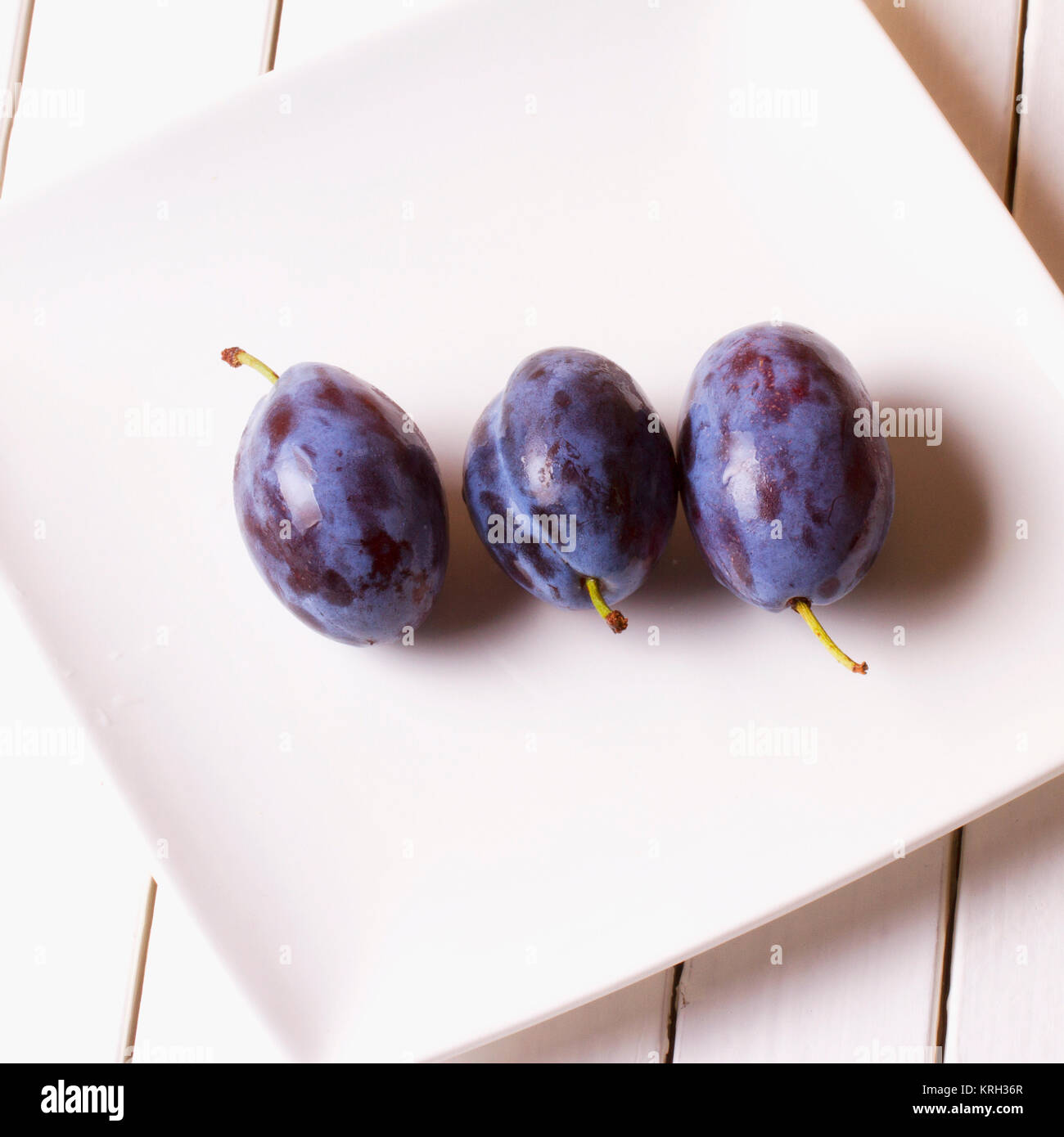 Prunes over a white plate Stock Photo - Alamy