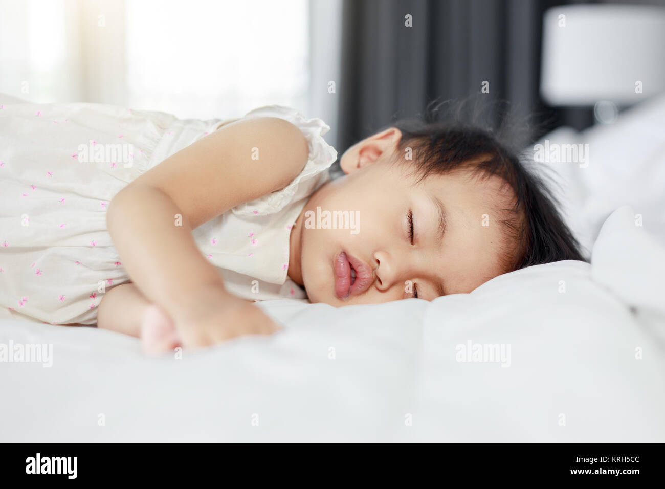 baby sleeping on bed in bedroom at home Stock Photo Alamy