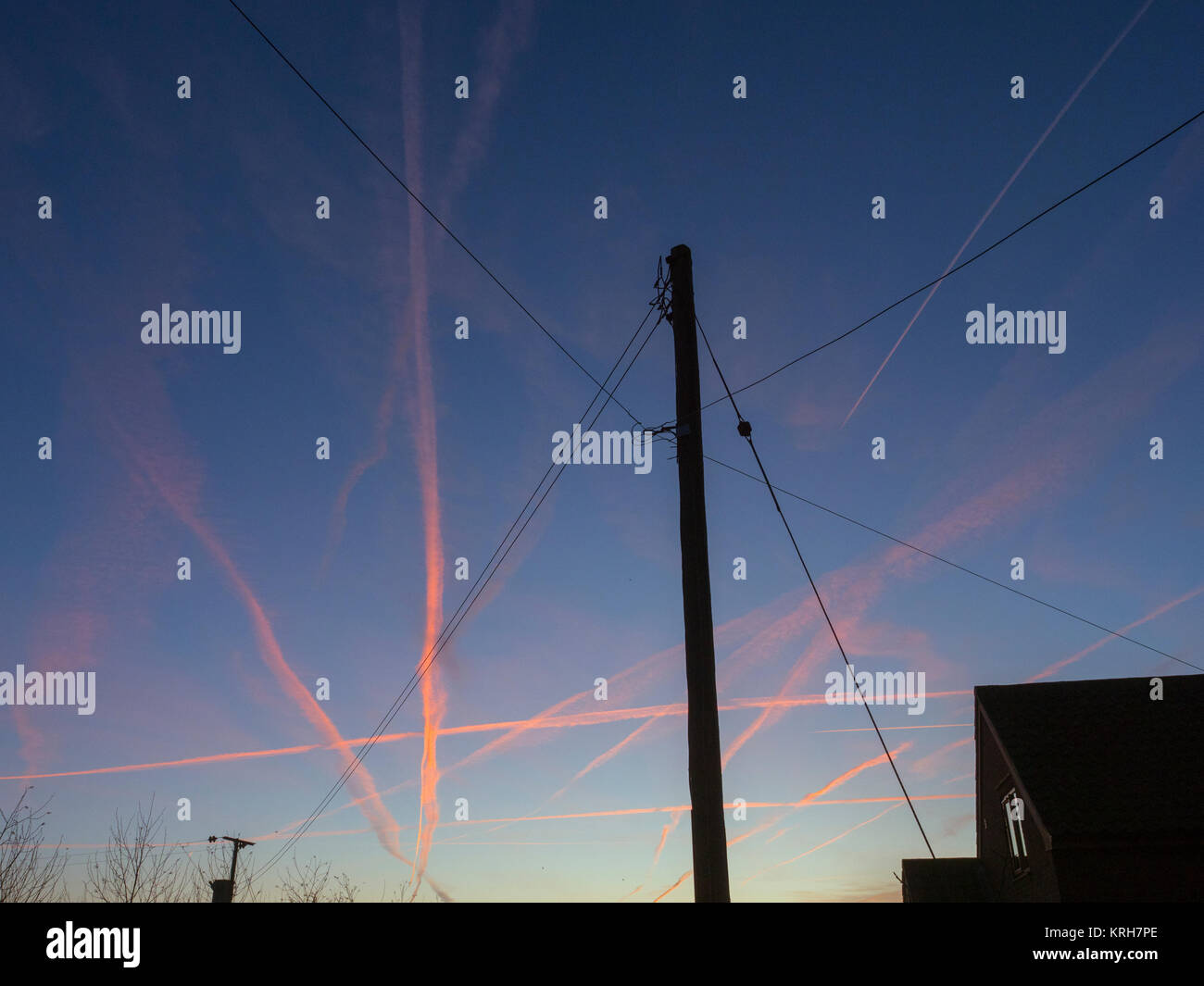 Jet trails at dawn over North Norfolk Stock Photo