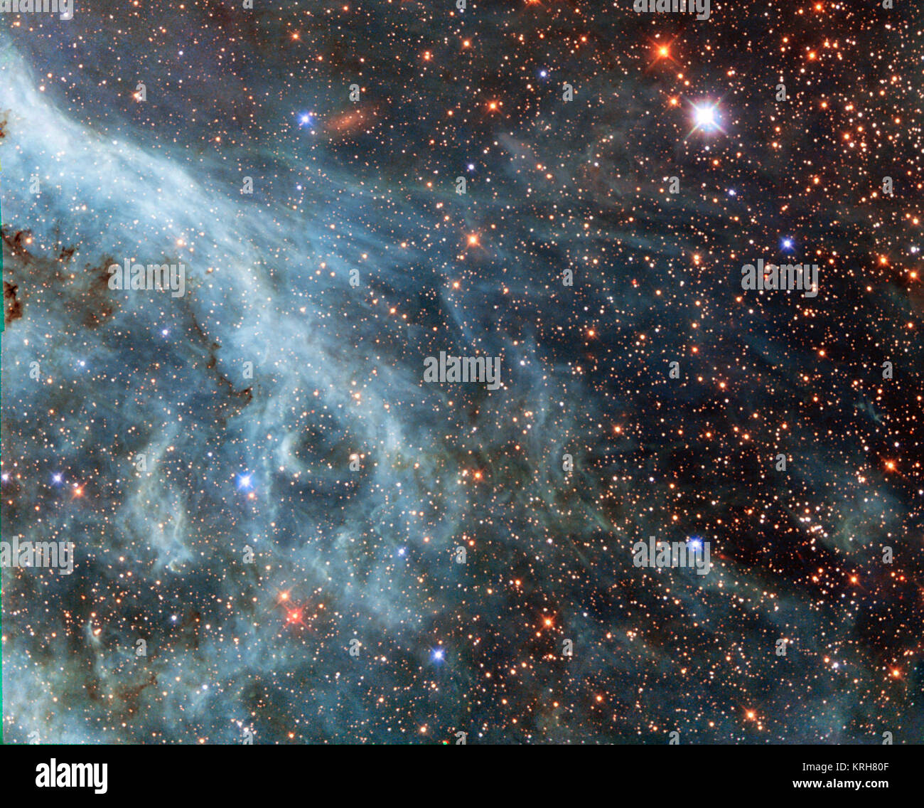 The brightly glowing plumes seen in this image are reminiscent of an underwater scene, with turquoise-tinted currents and nebulous strands reaching out into the surroundings. However, this is no ocean. This image actually shows part of the Large Magellanic Cloud (LMC), a small nearby galaxy that orbits our galaxy, the Milky Way, and appears as a blurred blob in our skies. The NASA/ESA Hubble Space Telescope has peeked many times into this galaxy, releasing stunning images of the whirling clouds of gas and sparkling stars (opo9944a, heic1301, potw1408a). This image shows part of the Tarantula N Stock Photo