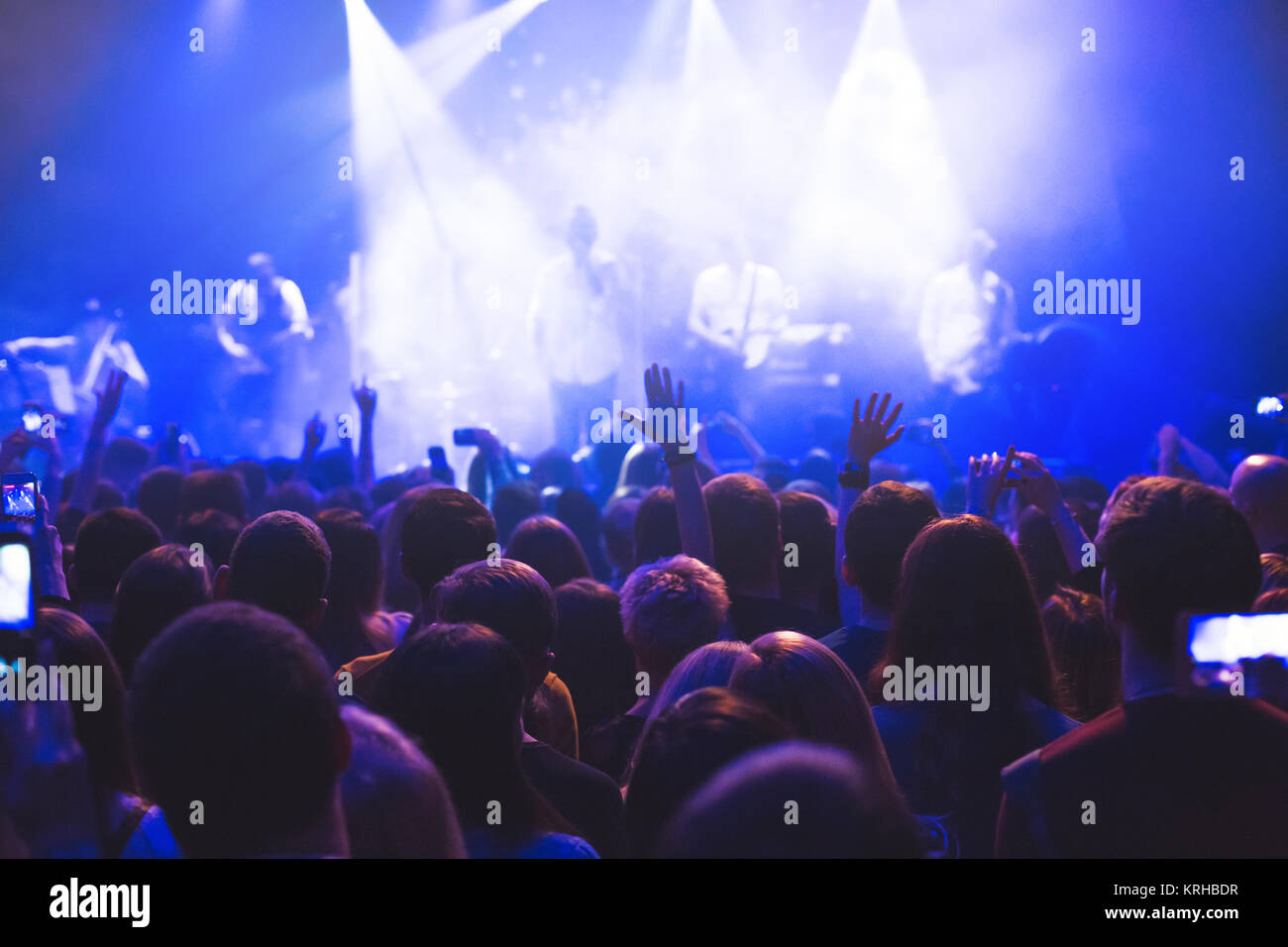 The audience watching the concert on stage Stock Photo - Alamy