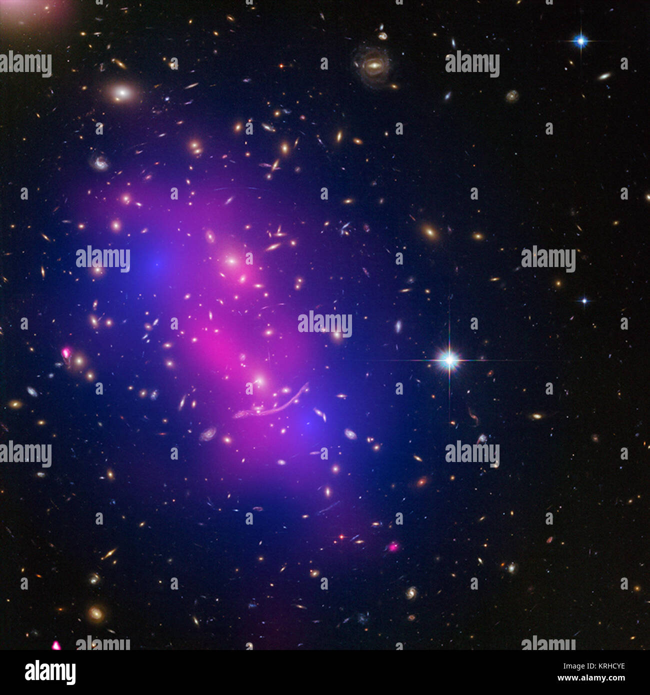 These galaxy clusters are part of a large study using Chandra and Hubble that sets new limits on how dark matter - the mysterious substance that makes up most of the matter in the Universe - interacts with itself. The hot gas that envelopes the clusters glows brightly in X-rays detected by Chandra (pink). When combined with Hubble's visible light data, astronomers can map where the stars and hot gas are after the collision, as well as the inferred distribution of dark matter (blue) through the effect of gravitational lensing. Abell 370 (Chandra) dark a370 Stock Photo
