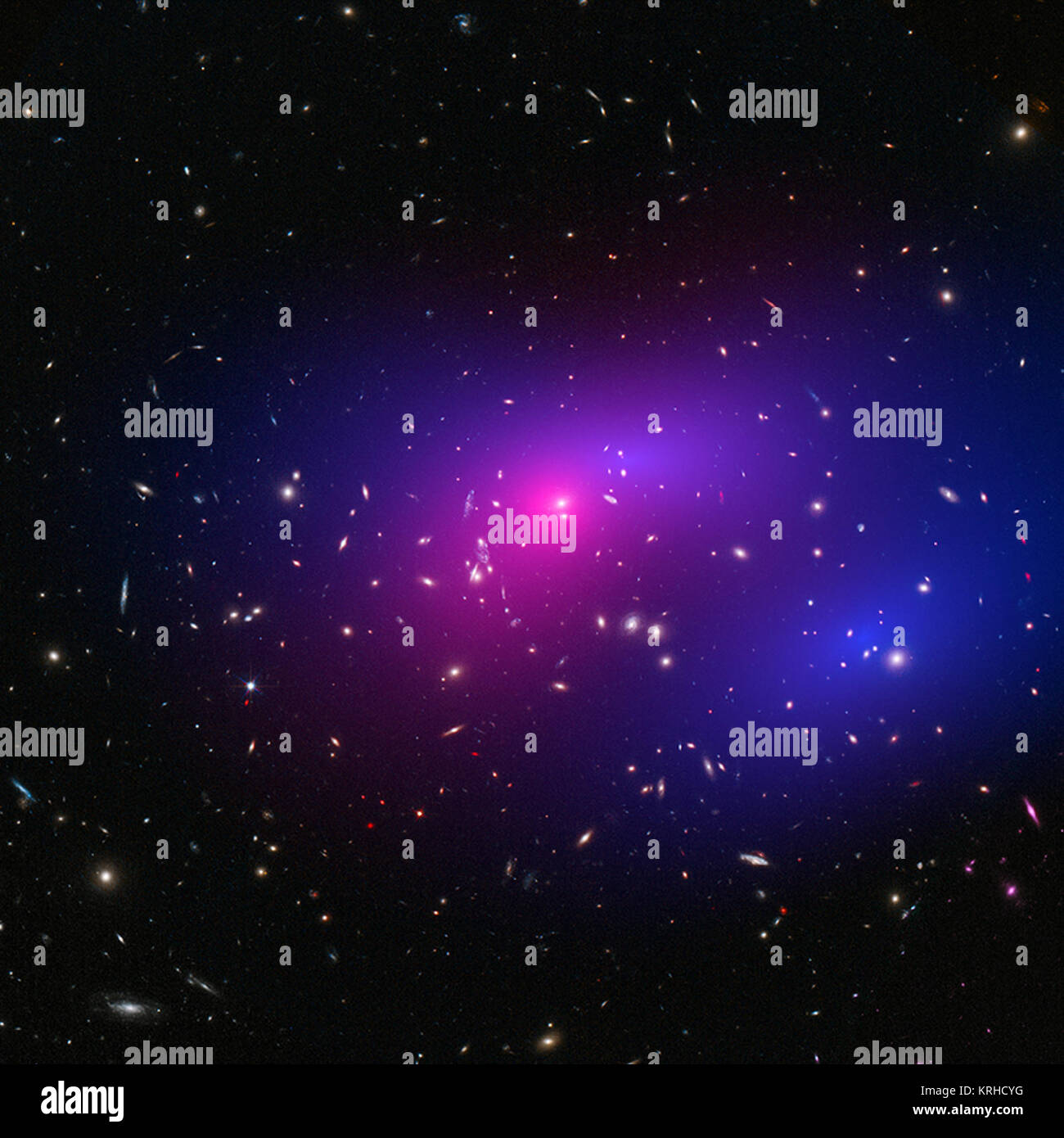 These galaxy clusters are part of a large study using Chandra and Hubble that sets new limits on how dark matter - the mysterious substance that makes up most of the matter in the Universe - interacts with itself. The hot gas that envelopes the clusters glows brightly in X-rays detected by Chandra (pink). When combined with Hubble's visible light data, astronomers can map where the stars and hot gas are after the collision, as well as the inferred distribution of dark matter (blue) through the effect of gravitational lensing. MACS J0152.5-2852 (HST & Chandra) dark macsj0152 Stock Photo