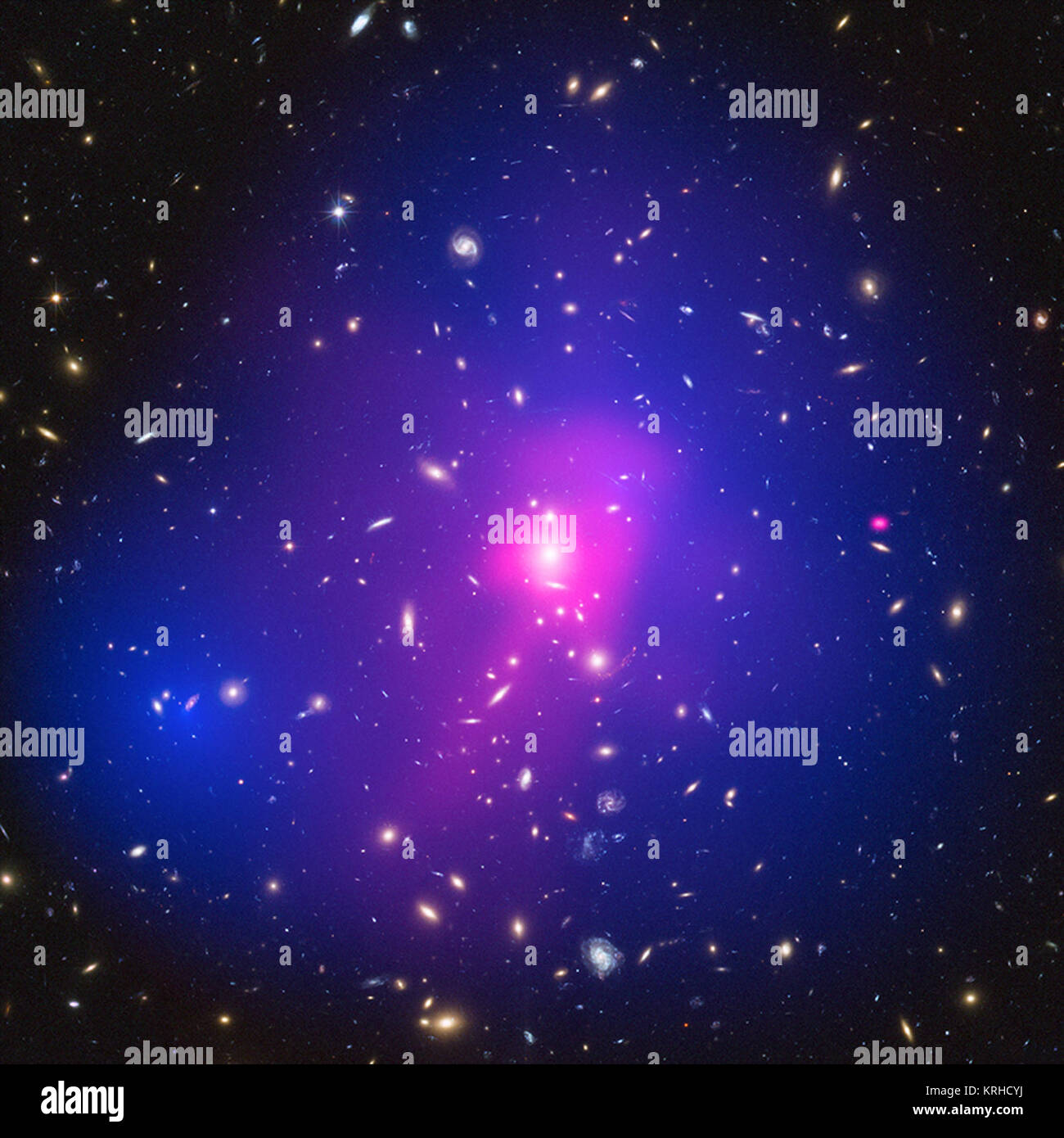 These galaxy clusters are part of a large study using Chandra and Hubble that sets new limits on how dark matter - the mysterious substance that makes up most of the matter in the Universe - interacts with itself. The hot gas that envelopes the clusters glows brightly in X-rays detected by Chandra (pink). When combined with Hubble's visible light data, astronomers can map where the stars and hot gas are after the collision, as well as the inferred distribution of dark matter (blue) through the effect of gravitational lensing. ZwCl 1358 62 (Chandra & Hubble) Stock Photo