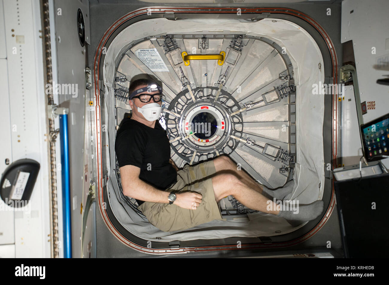 ISS-43 Terry Virts sits is one of the hatchways Stock Photo