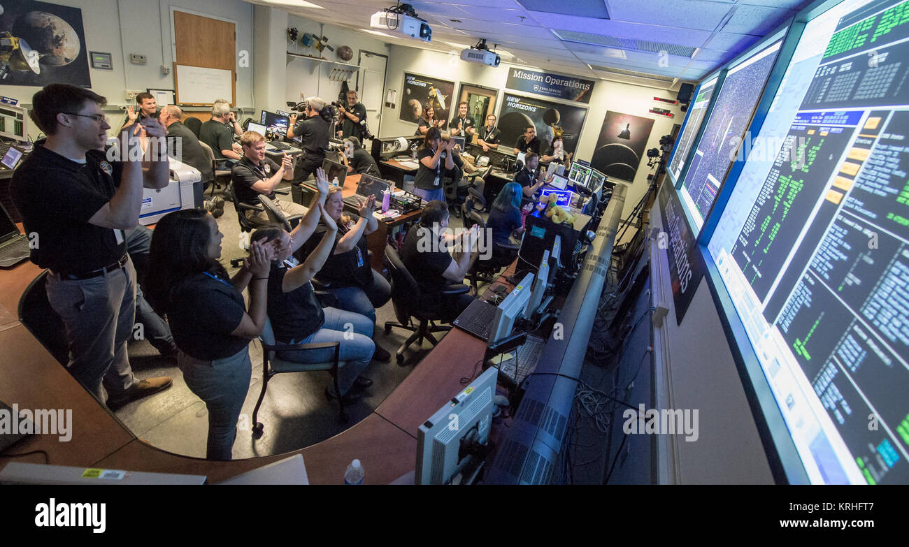 New Horizons Flight Controllers celebrate after they received confirmation from the spacecraft that it had successfully completed the flyby of Pluto, Tuesday, July 14, 2015 in the Mission Operations Center (MOC) of the Johns Hopkins University Applied Physics Laboratory (APL), Laurel, Maryland. Photo Credit: (NASA/Bill Ingalls) 15-150-NasaTeam-NewHorizonsCallsHomeAfterPlutoFlyby-20150714 Stock Photo