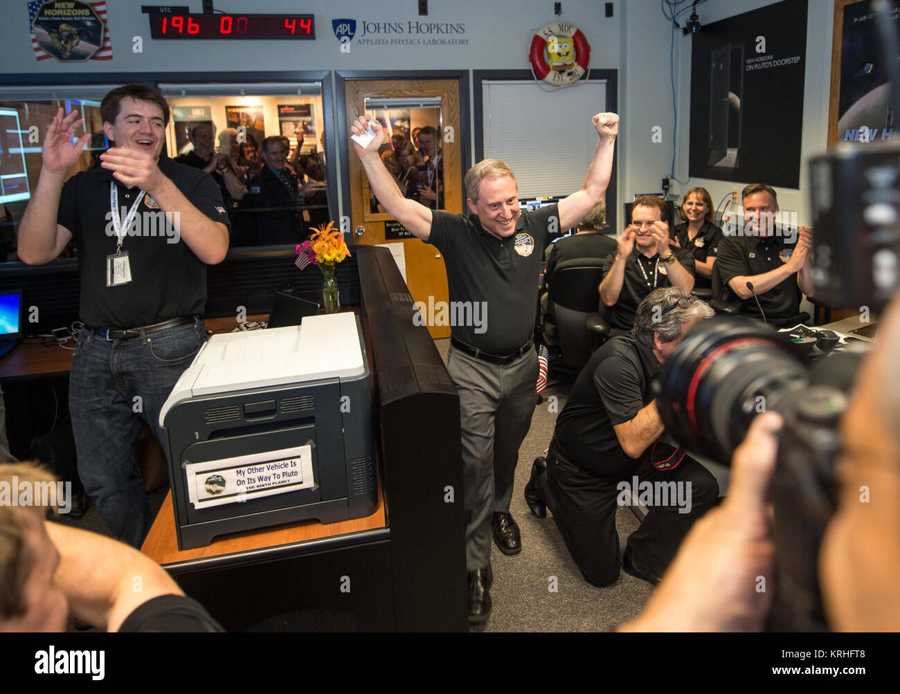 New Horizons Principal Investigator Alan Stern of Southwest Research Institute (SwRI), Boulder, CO. celebrates with New Horizons Flight Controllers after they received confirmation from the spacecraft that it had successfully completed the flyby of Pluto, Tuesday, July 14, 2015 in the Mission Operations Center (MOC) of the Johns Hopkins University Applied Physics Laboratory (APL), Laurel, Maryland. Photo Credit: (NASA/Bill Ingalls) Alan Stern and New Horizons Team Celebrate Pluto Flyby Stock Photo