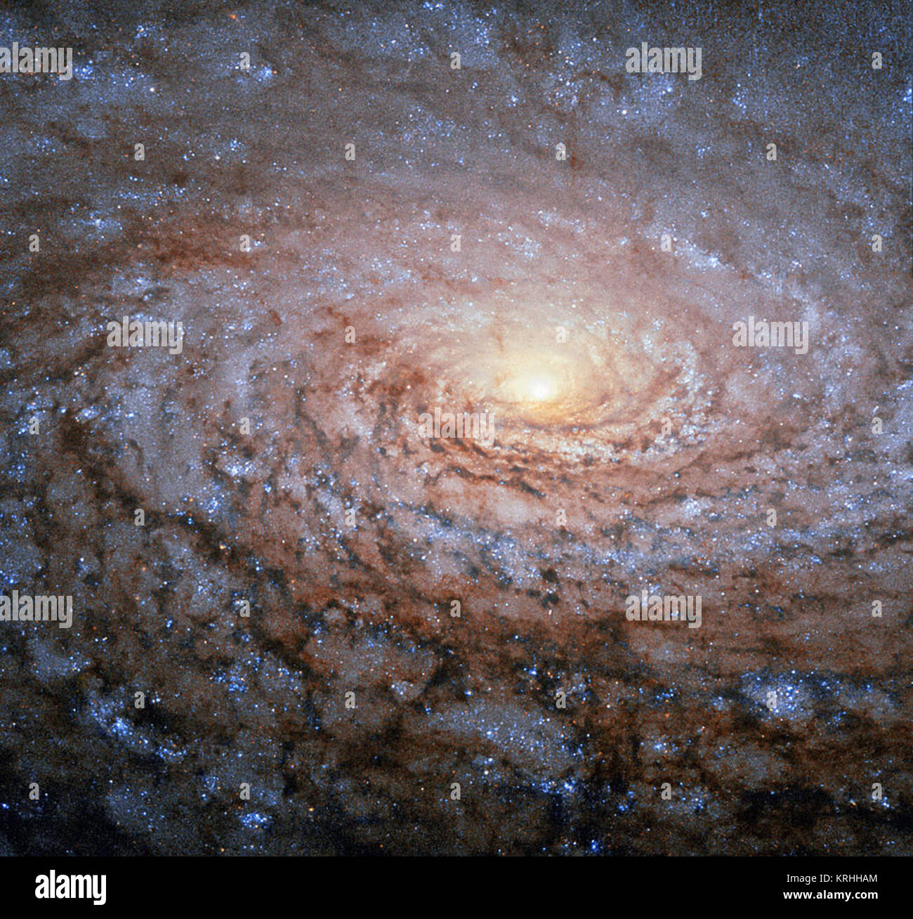 The arrangement of the spiral arms in the galaxy Messier 63, seen here in a new image from the NASA/ESA Hubble Space Telescope, recall the pattern at the centre of a sunflower. So the nickname for this cosmic object — the Sunflower Galaxy — is no coincidence. Discovered by Pierre Mechain in 1779, the galaxy later made it as the 63rd entry into fellow French astronomer Charles Messier’s famous catalogue, published in 1781. The two astronomers spotted the Sunflower Galaxy’s glow in the small, northern constellation Canes Venatici (the Hunting Dogs). We now know this galaxy is about 27 million li Stock Photo