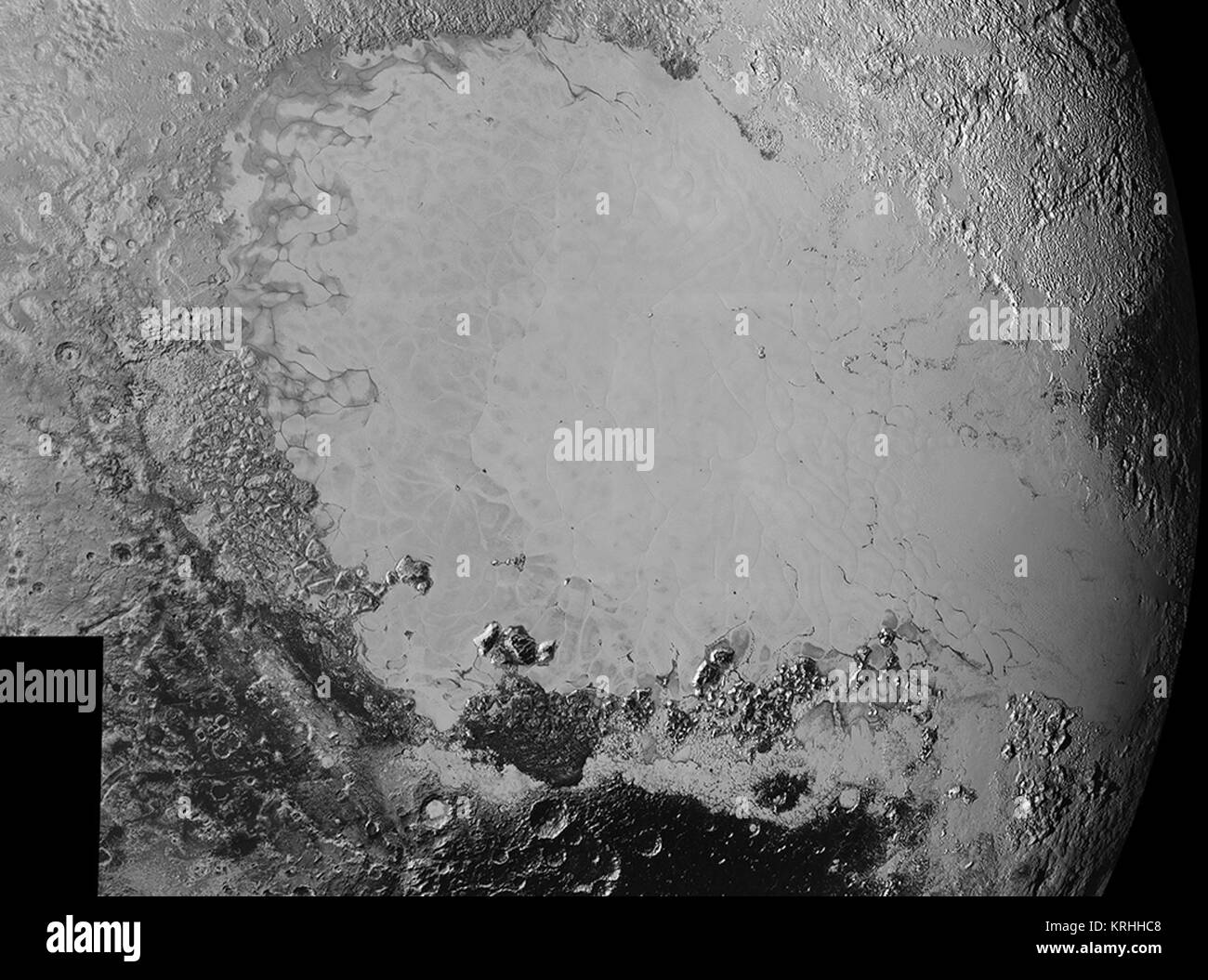 Mosaic of high-resolution images of Pluto, sent back from NASA’s New Horizons spacecraft from Sept. 5 to 7, 2015. The image is dominated by the informally-named icy plain Sputnik Planum, the smooth, bright region across the center. This image also features a tremendous variety of other landscapes surrounding Sputnik. The smallest visible features are 0.5 miles (0.8 kilometers) in size, and the mosaic covers a region roughly 1,000 miles (1600 kilometers) wide. The image was taken as New Horizons flew past Pluto on July 14, 2015, from a distance of 50,000 miles (80,000 kilometers). Credits: NASA Stock Photo