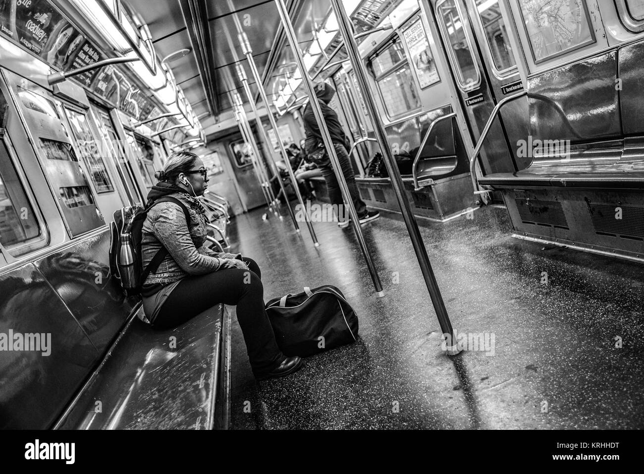 New York City, US, 22nd April 2017 - Woma Listen's to music whilst travelling on New York City Subway Stock Photo