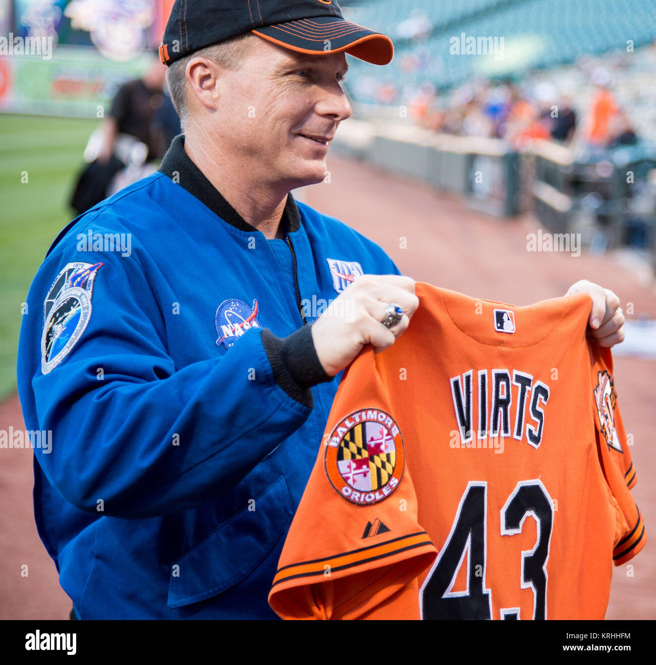 NASA astronaut and Maryland native, Terry Virts holds the jersey that he flew aboard the International Space Station before presenting it to Baltimore Orioles manager Buck Showalter prior to the Boston Red Sox takeing on the Baltimore Orioles at Camden Yards in Baltimore, Md. on Monday, September 14, 2015.  Virts spend 199 days aboard the International Space Station from November 2014 to June 2015 as part of Expeditions 42 and 43, serving as commander of Expedition 43.  Photo Credit: (NASA/Joel Kowsky) Astronaut Terry Virts Orioles First Pitch (NHQ201509140013) Stock Photo
