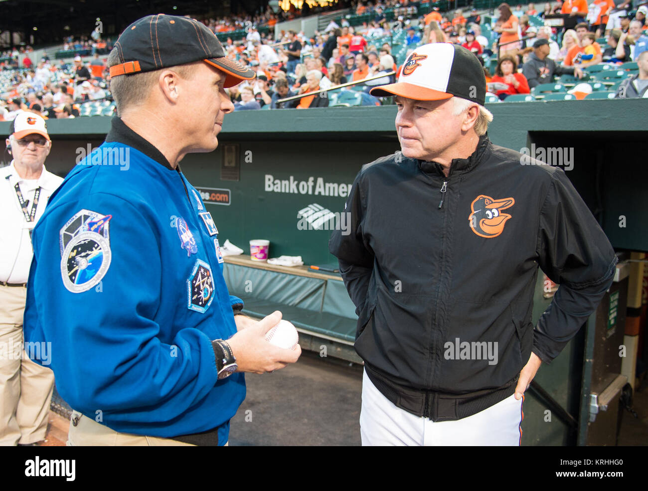 NASA astronaut and Maryland native Terry Virts, left, talks with Baltimore Orioles manager Buck Showalter after throwing out the first pitch before the Boston Red Sox take on the Baltimore Orioles at Camden Yards in Baltimore, Md. on Monday, September 14, 2015.  Virts spend 199 days aboard the International Space Station from November 2014 to June 2015 as part of Expeditions 42 and 43, serving as commander of Expedition 43.  Photo Credit: (NASA/Joel Kowsky) Astronaut Terry Virts Orioles First Pitch (NHQ201509140015) Stock Photo