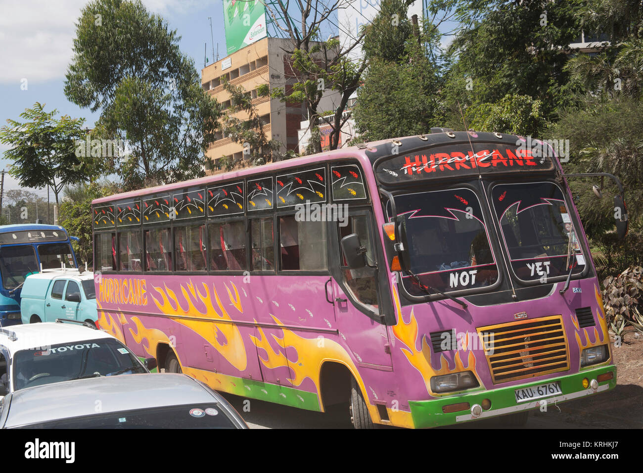 Brightly coloured traditional shared taxis or matatu buses in the capital of Kenya, Nairobi, East Africa Stock Photo