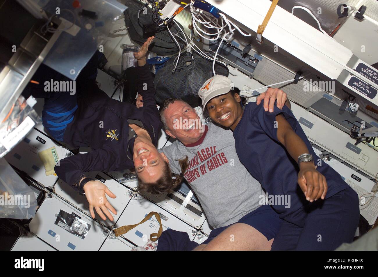 NASA Space Shuttle Discovery International Space Station STS-121 mission prime crew members American astronauts (L-R) Lisa Nowak, Michael Fossum, and Stephanie Wilson float in the Discovery middeck Airlock July 8, 2006 in Earth orbit. Stock Photo