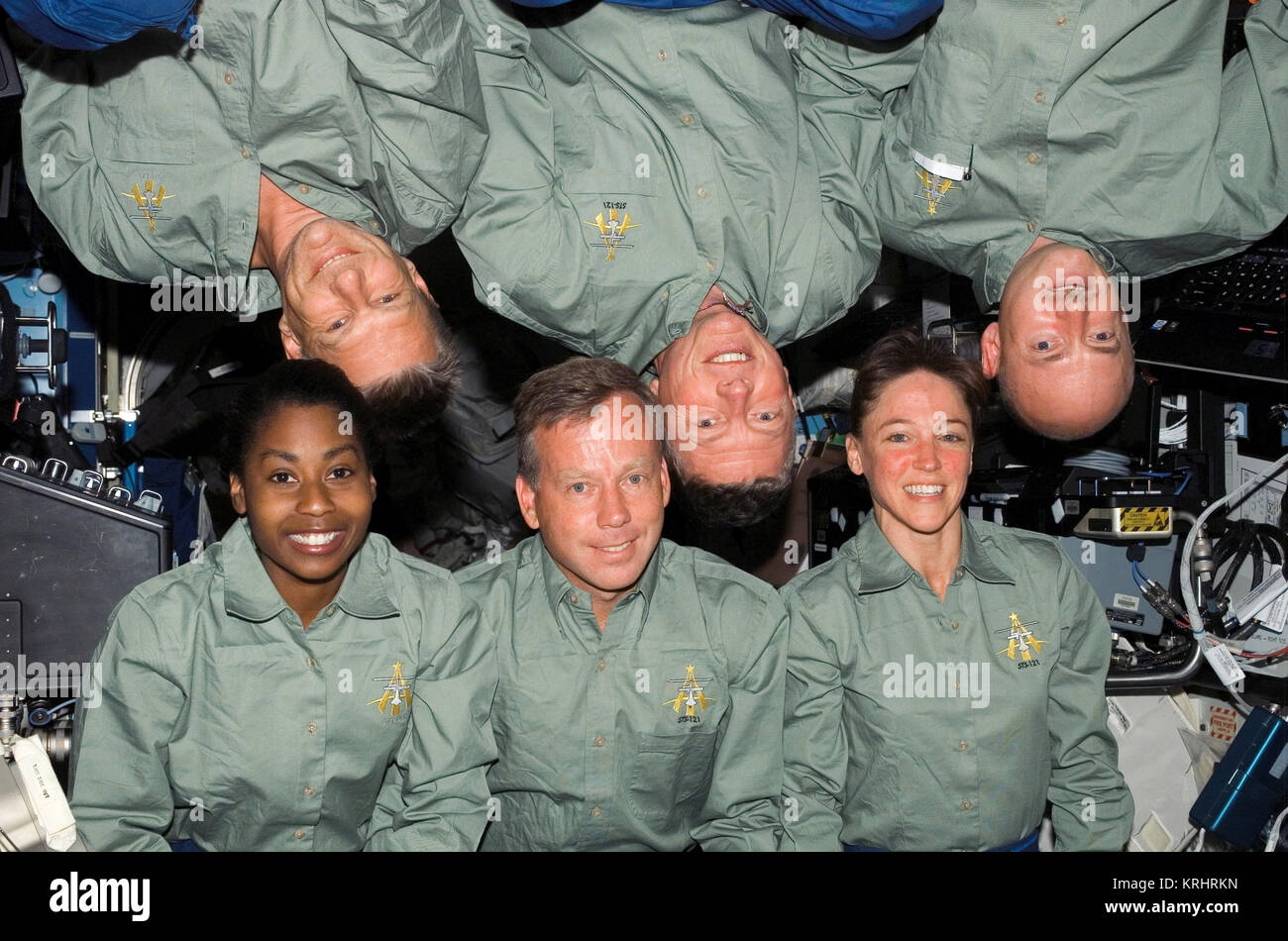 NASA Space Shuttle Discovery International Space Station STS-121 mission prime crew members (bottom, L-R) American astronauts Stephanie Wilson, Steven Lindsey, Lisa Nowak (top, L-R) Piers Sellers, Michael Fossum and Mark Kelly gather for a group photo in the ISS Destiny Laboratory July 9, 2006 in Earth orbit. Stock Photo