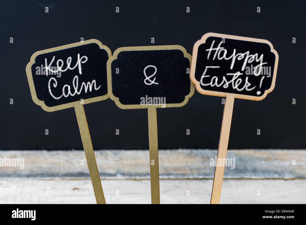 Keep Calm and Happy Easter message written with chalk on mini blackboard labels Stock Photo