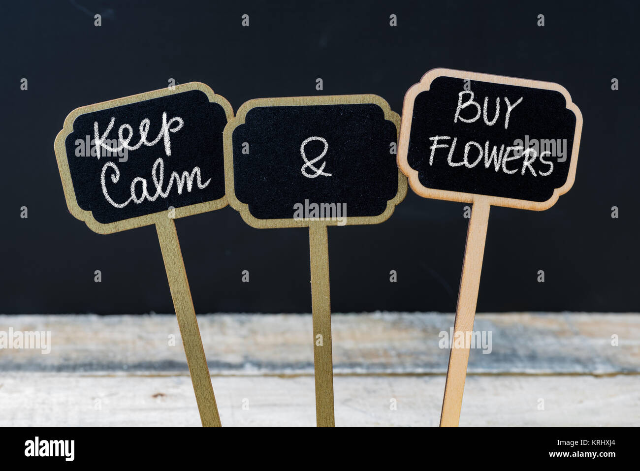 Keep Calm and Buy Flowers message written with chalk on mini blackboard labels Stock Photo