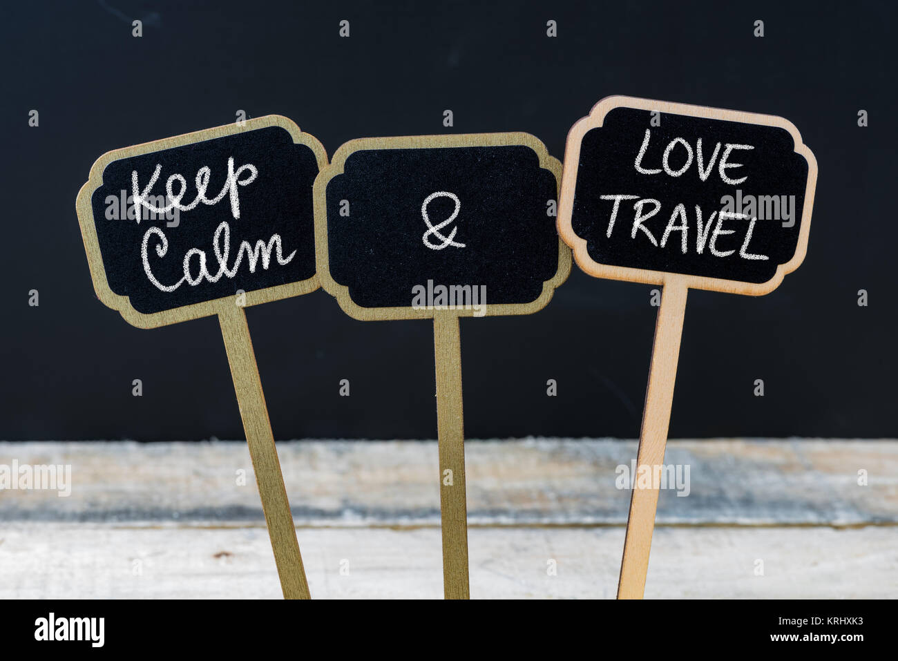 Keep Calm and Love Travel message written with chalk on mini blackboard labels Stock Photo