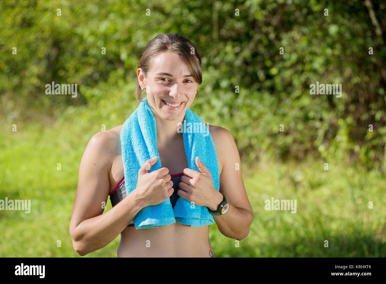 young sporty woman with blue towel in the countryside Stock Photo - Alamy