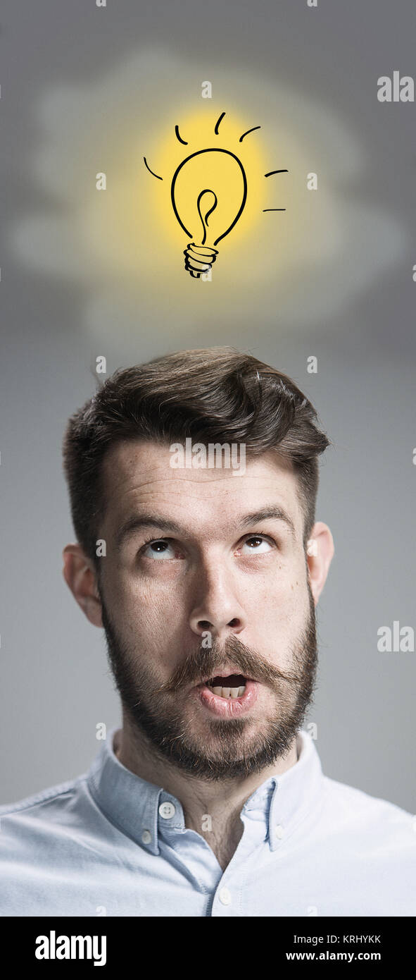 Man is looking reminiscing. Over gray background Stock Photo