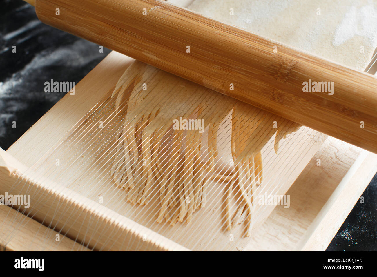 Making spaghetti alla chitarra with a tool Stock Photo Alamy