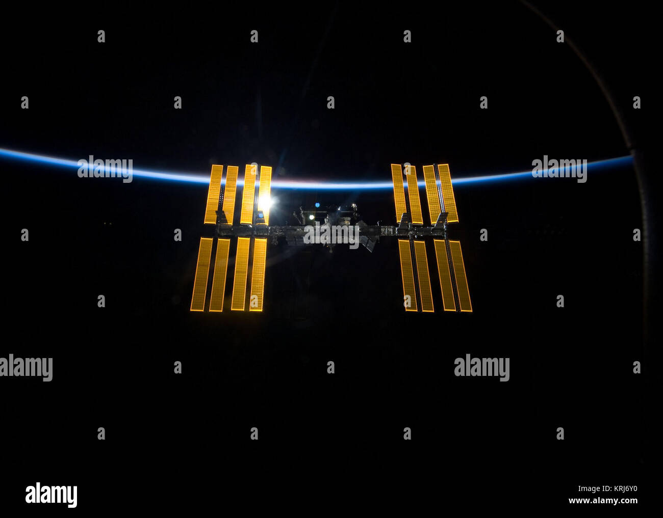 STS-119 International Space Station after undocking with earth atmosphere backdrop Stock Photo