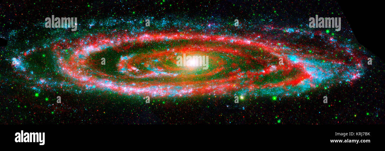 The many 'personalities' of our great galactic neighbor, the Andromeda galaxy, are exposed in this new composite image from NASA's Galaxy Evolution Explorer and the Spitzer Space Telescope.  The wide, ultraviolet eyes of Galaxy Evolution Explorer reveal Andromeda's 'fiery' nature -- hotter regions brimming with young and old stars. In contrast, Spitzer's super-sensitive infrared eyes show Andromeda's relatively 'cool' side, which includes embryonic stars hidden in their dusty cocoons.  Galaxy Evolution Explorer detected young, hot, high-mass stars, which are represented in blue, while populati Stock Photo