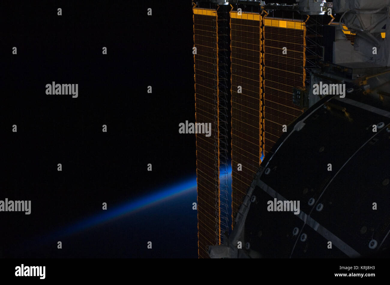 ISS solar panel intersecting Earth's horizon Stock Photo