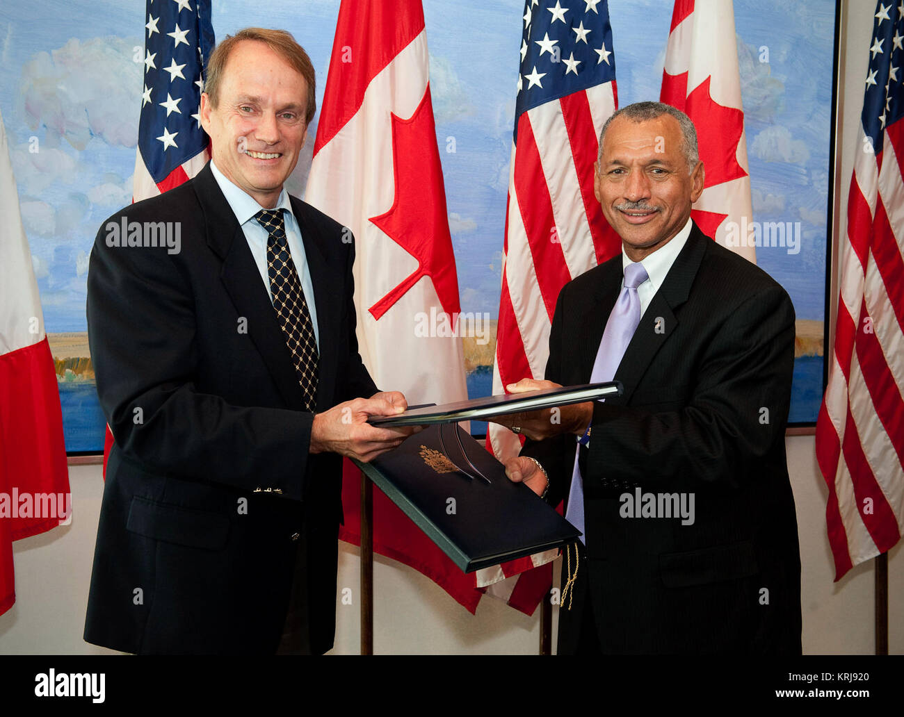 NASA Administrator Charles Bolden, right, and Canadian Space Agency President Steve MacLean signed a framework agreement on civil space cooperation, Wednesday, Sept. 9, 2009, at the Canadian Embassy in Washington, DC.  Photo Credit: (NASA/Bill Ingalls)  NASA Identifier: nasahqphoto-3907836896 NASA Administrator Charles Bolden and Canadian Space Agency President Steve MacLean Stock Photo