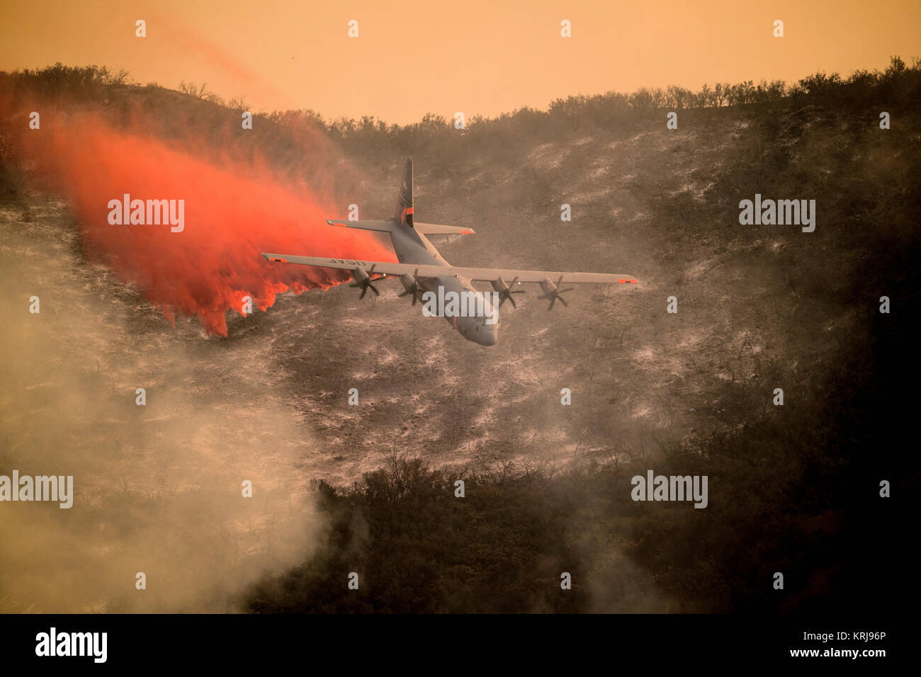 A U.S. Air National Guard C-130J Hercules aircraft equipped with the MAFFS 2 (Modular Airborne Fire Fighting System) drops a line of fire retardant on the Thomas Fire in the hills above the city of Santa Barbara, California, Dec. 13, 2017. The 146th Airlift Wing has been supporting CAL FIRE’s efforts to battle the Thomas Fire raging in Southern California. (U.S. Air National Guard Stock Photo