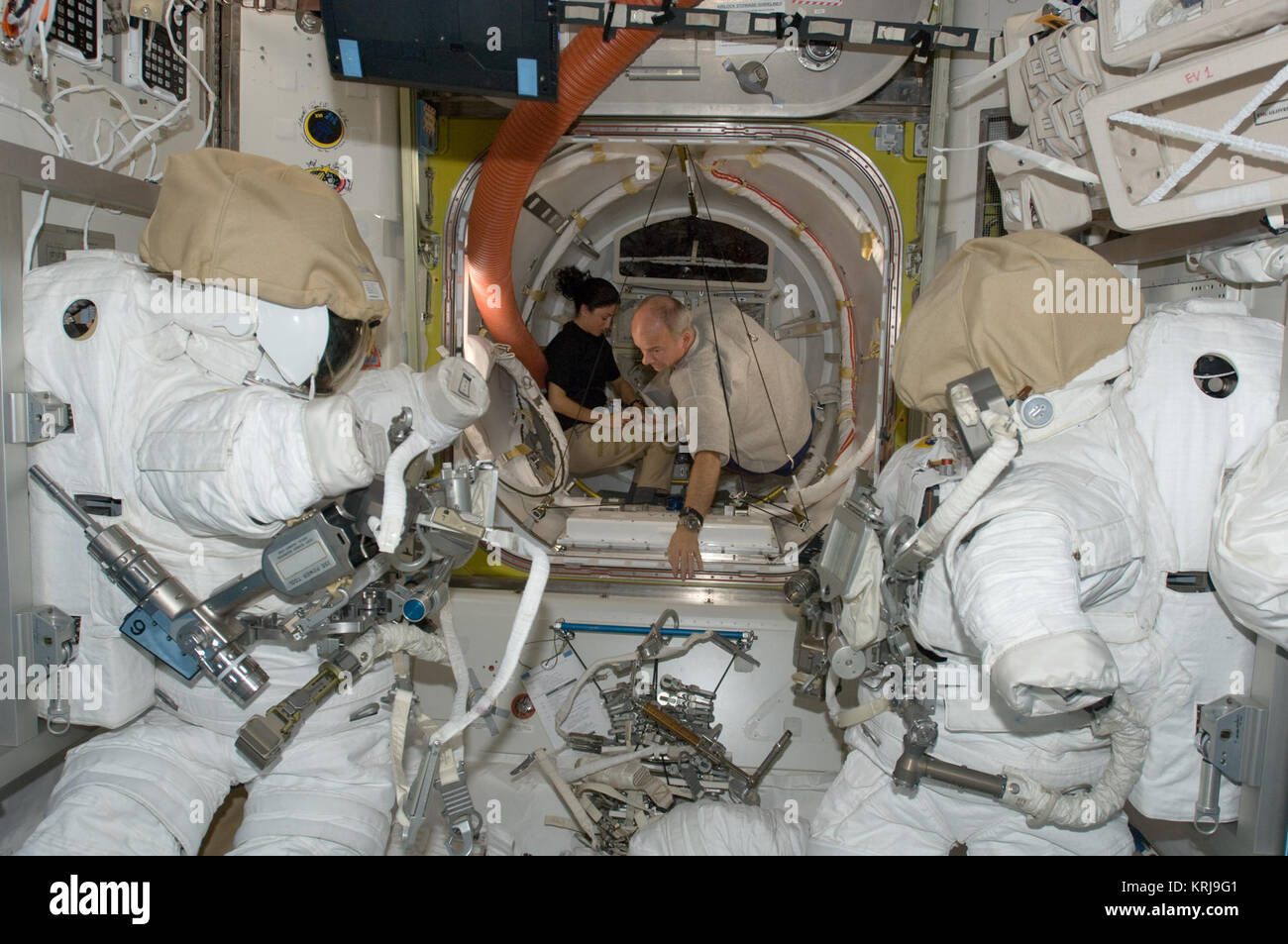 ISS21 Nicole Stott and Jeffrey Williams work in the Quest airlock
