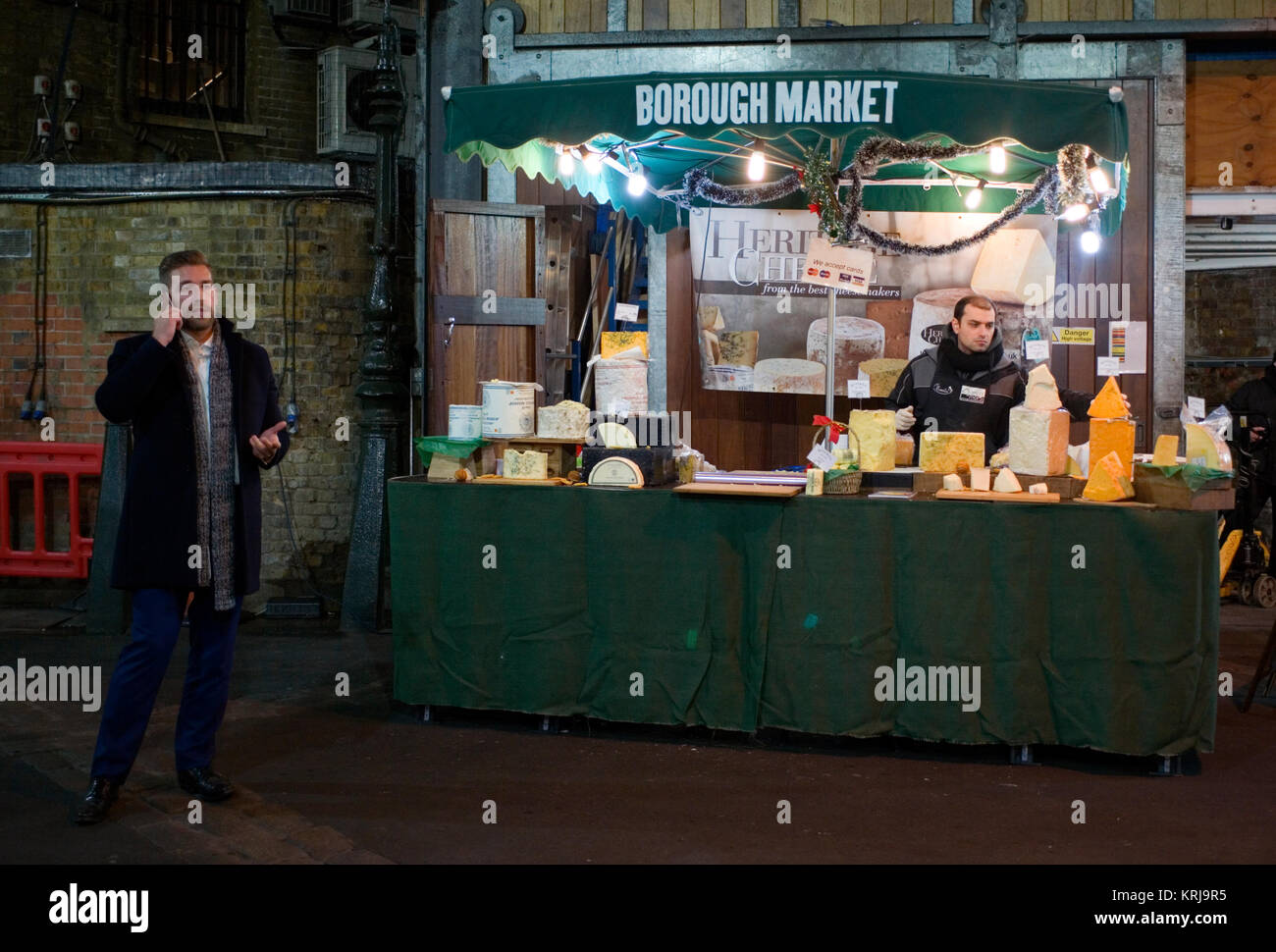 A food stall is lit as evening falls over Borough Market, in London, Britain December 19, 2017 Stock Photo