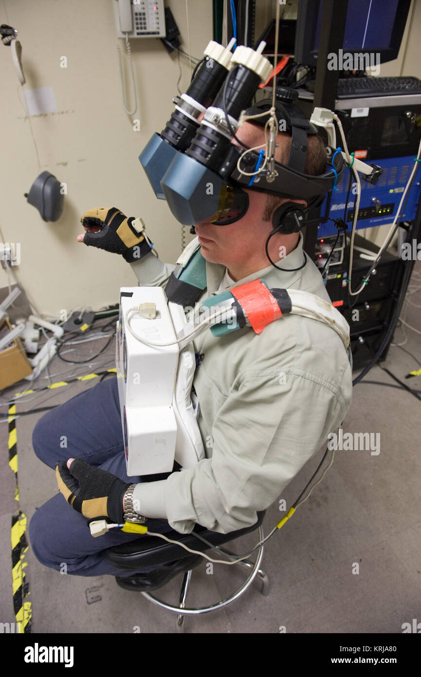 PHOTO DATE: 01-28-10 LOCATION: Bldg. 9 - VR Lab  SUBJECT:  STS-132 crew during their MSS/SIMP EVA3 OPS 4 training with Expedition 23 crew member Tracy Caldwell Dyson. Instructor is Madhurita Sengupta. PHOTOGRAPHER:  James Blair STS-132 Garrett Reisman uses VR hardware Stock Photo